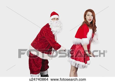 Picture - Portrait of Santa touching Mrs. Santa inappropriately against gray background. Fotosearch