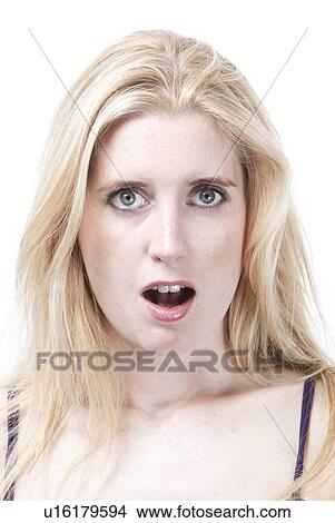 Portrait of surprised young Caucasian woman against white background View Large Photo Image Picture - Portrait of surprised young Caucasian woman against white background. Fotosearch