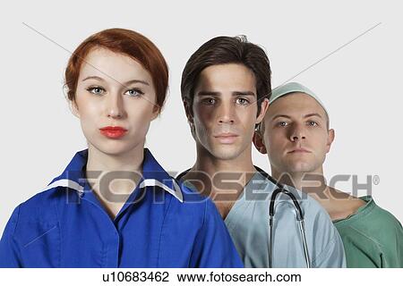 Stock Image - Portrait of three confident medical practitioners against gray background. Fotosearch