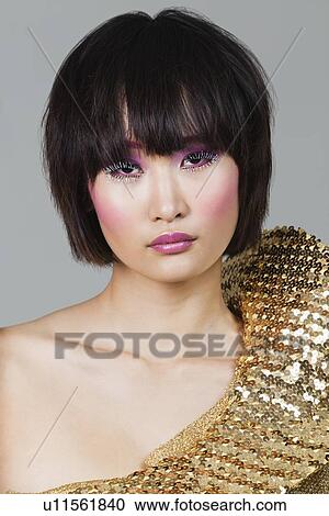 Portrait of woman in golden costume over gray background View Large Photo Image Stock Image - Portrait of woman in golden costume over gray background. Fotosearch
