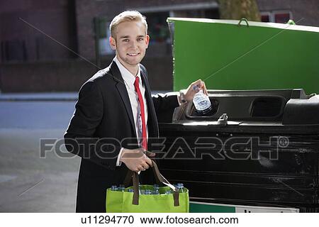 Portrait of young businessman throwing plastic bottles in bin View Large Photo Image Stock Image - Portrait of young businessman throwing plastic bottles in bin. Fotosearch