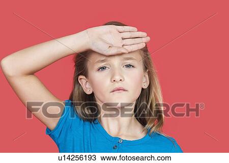 Portrait of young girl checking self temperature against red background View Large Photo Image Stock Image - Portrait of young girl checking self temperature against red background. Fotosearch