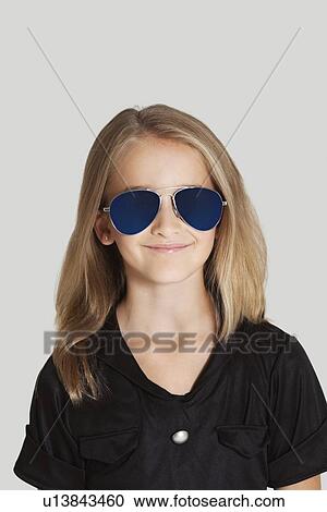 Portrait of young girl holding popcorn container against red background View Large Photo Image Stock Image - Portrait of young girl holding popcorn container against red background. Fotosearch