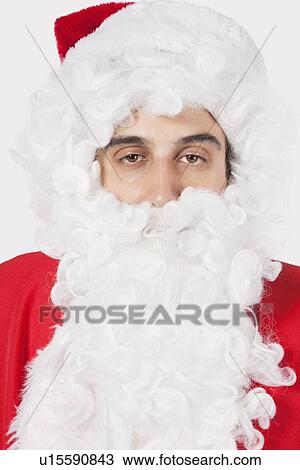 Portrait of young man in Santa costume against gray background View Large Photo Image Stock Image - Portrait of young man in Santa costume against gray background. Fotosearch