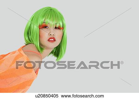 Portrait of young woman wearing green wig over gray background View Large Photo Image Stock Photography - Portrait of young woman wearing green wig over gray background. Fotosearch