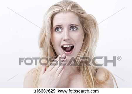 Surprised young woman with mouth open against white background View Large Photo Image Stock Photo - Surprised young woman with mouth open against white background. Fotosearch