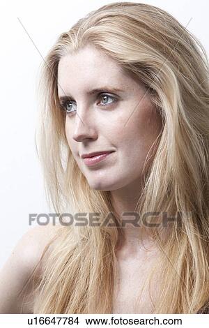 Thoughtful young woman looking away against white background View Large Photo Image Picture - Thoughtful young woman looking away against white background. Fotosearch