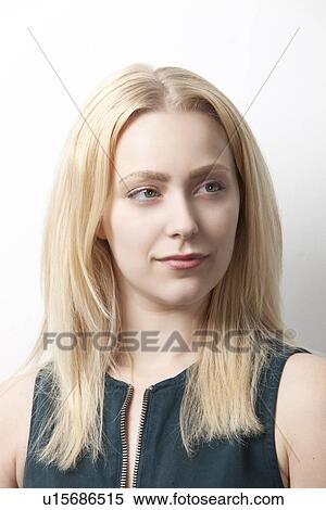 Stock Photography - Thoughtful young woman looking away against white background. Fotosearch