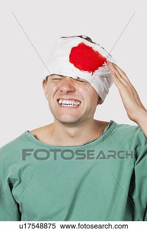 Young male patient with serious head injury against gray background View Large Photo Image Stock Photography - Young male patient with serious head injury against gray background. Fotosearch