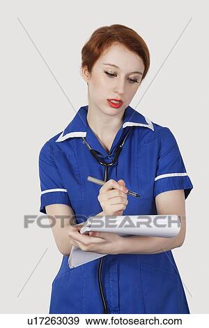 Young male surgeon and female nurse gesturing thumbs up against gray background View Large Photo Image Stock Photo - Young male surgeon and female nurse gesturing thumbs up against gray background. Fotosearch