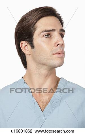 Young man in surgical scrubs against gray background View Large Photo Image Stock Image - Young man in surgical scrubs against gray background. Fotosearch