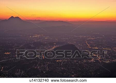 Stock Image - Aerial view of lit up city landscape. Fotosearch