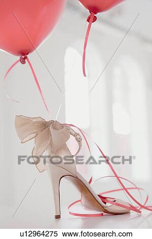 Stock Photography - Balloons attached to high heel. Fotosearch