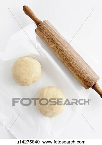 Stock Image - Balls of dough and rolling in. Fotosearch