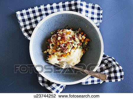 Stock Image - Bowl of mashed potato with bacon. Fotosearch