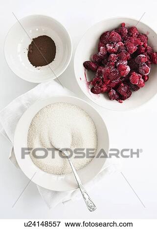 Stock Photo - Bowls of fruit, sugar and cocoa. Fotosearch
