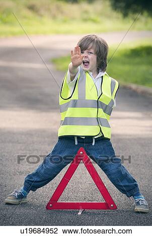 Boy playing traffic worker on rural road View Large Photo Image Stock Image - Boy playing traffic worker on rural road. Fotosearch
