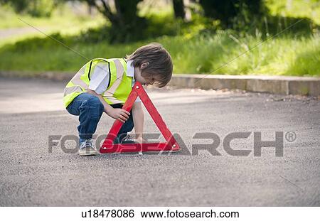 Boy playing traffic worker on rural road View Large Photo Image Stock Photograph - Boy playing traffic worker on rural road. Fotosearch