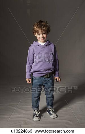 Stock Image - Boy smiling in studio. Fotosearch