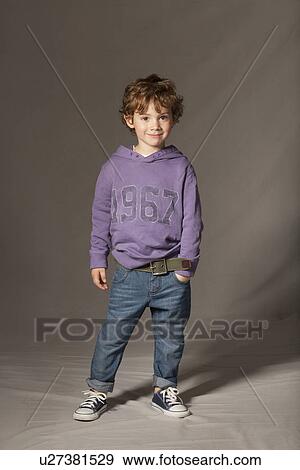 Boy smiling in studio View Large Photo Image Stock Photo - Boy smiling in studio. Fotosearch
