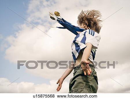 Stock Photo - Boy with medals cheering outdoors. Fotosearch
