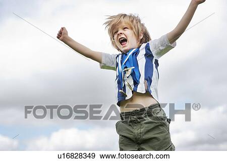 Boy with medals cheering outdoors View Large Photo Image Stock Photo - Boy with medals cheering outdoors. Fotosearch