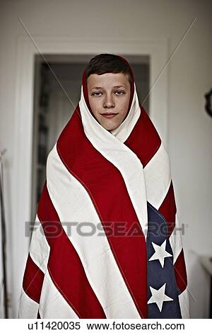 Boy wrapped in American flag indoors View Large Photo Image Stock Photography - Boy wrapped in American flag indoors. Fotosearch