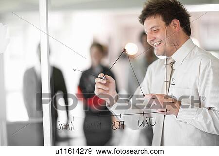 Stock Photo - Businessman drawing graph on window. Fotosearch