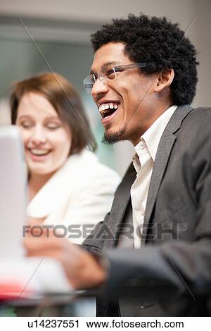 Businessman laughing in meeting View Large Photo Image Stock Image - Businessman laughing in meeting. Fotosearch