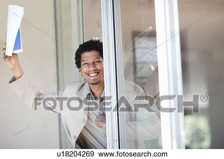 Businessman leaning in glass door View Large Photo Image Stock Photo - Businessman leaning in glass door . Fotosearch