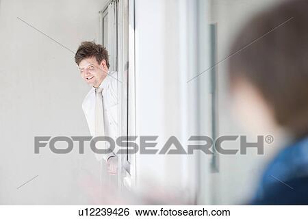 Businessman leaning out window View Large Photo Image Stock Photograph - Businessman leaning out window. Fotosearch