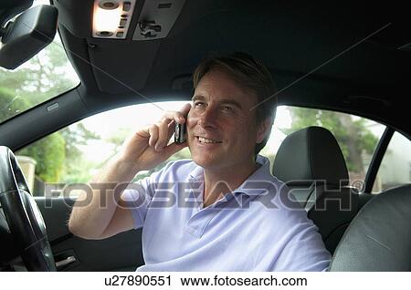 Businessman on cell phone and driving View Large Photo Image Stock Image - Businessman on cell phone and driving. Fotosearch