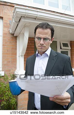 Businessman reading with cup of coffee View Large Photo Image Stock Image - Businessman reading with cup of coffee. Fotosearch