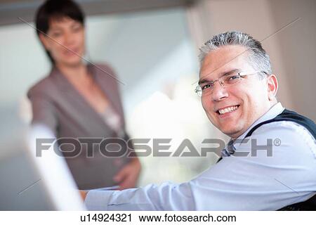 Businessman smiling in meeting View Large Photo Image Stock Image - Businessman smiling in meeting. Fotosearch