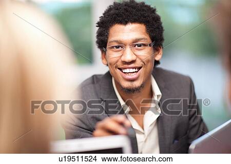Businessman talking in meeting View Large Photo Image Picture - Businessman talking in meeting. Fotosearch
