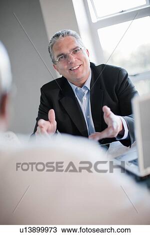 Businessman talking in meeting View Large Photo Image Stock Image - Businessman talking in meeting. Fotosearch