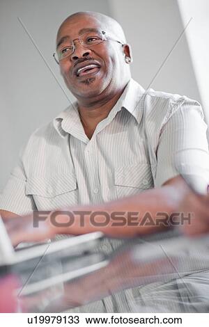 Stock Image - Businessman talking in meeting. Fotosearch
