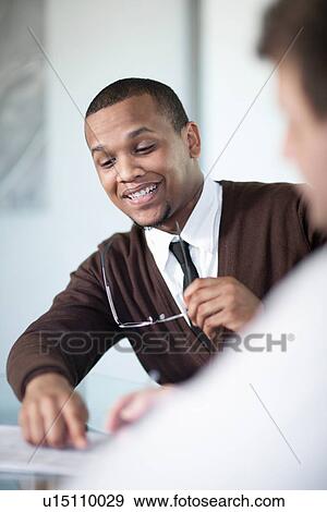 Businessman talking in meeting View Large Photo Image Stock Photo - Businessman talking in meeting. Fotosearch