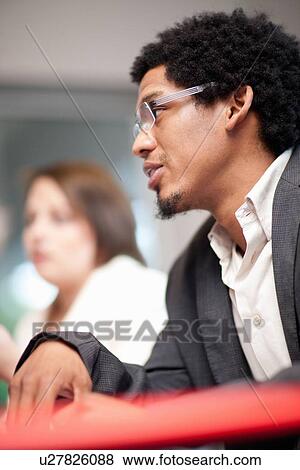 Businessman talking in meeting View Large Photo Image Stock Photo - Businessman talking in meeting. Fotosearch