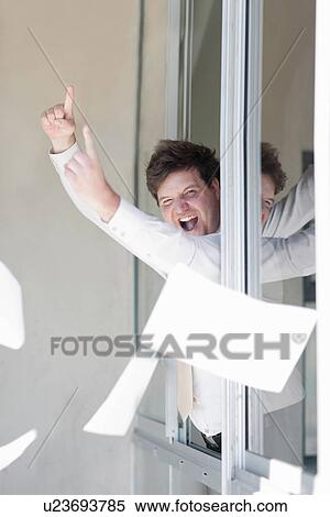 Businessman throwing papers out window View Large Photo Image Stock Photography - Businessman throwing papers out window. Fotosearch