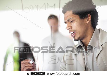 Businessman writing on window View Large Photo Image Stock Photograph - Businessman writing on window. Fotosearch