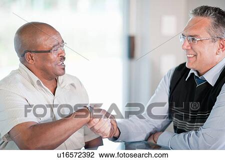 Businessmen shaking hands in meeting View Large Photo Image Stock Image - Businessmen shaking hands in meeting. Fotosearch