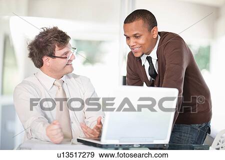 Stock Photo - Businessmen talking in meeting. Fotosearch