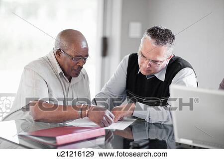 Stock Photo - Businessmen talking in meeting. Fotosearch