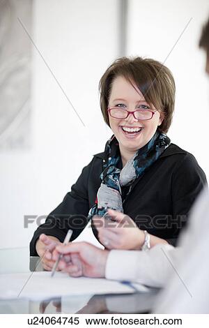 Businesswoman laughing in meeting View Large Photo Image Stock Photography - Businesswoman laughing in meeting. Fotosearch