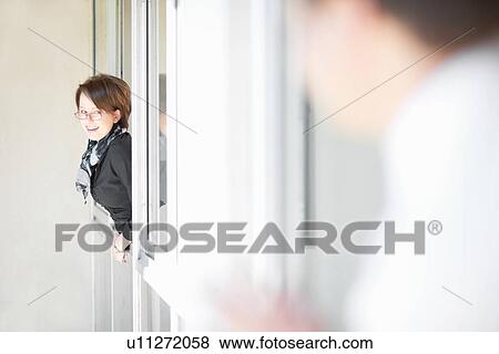 Businesswoman leaning out window View Large Photo Image Stock Photo - Businesswoman leaning out window. Fotosearch