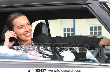 Businesswoman on cell phone and driving View Large Photo Image Stock Photo - Businesswoman on cell phone and driving. Fotosearch