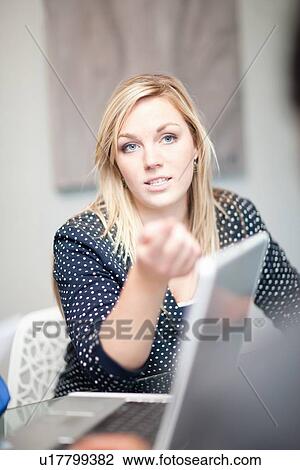 Stock Image - Businesswoman talking in meeting. Fotosearch
