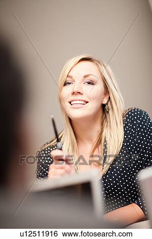 Stock Photograph - Businesswoman talking in meeting. Fotosearch