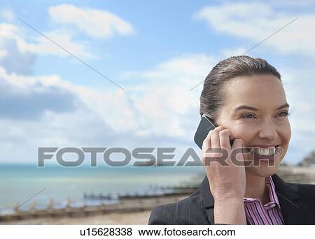 Stock Photo - Businesswoman talking on cell phone. Fotosearch